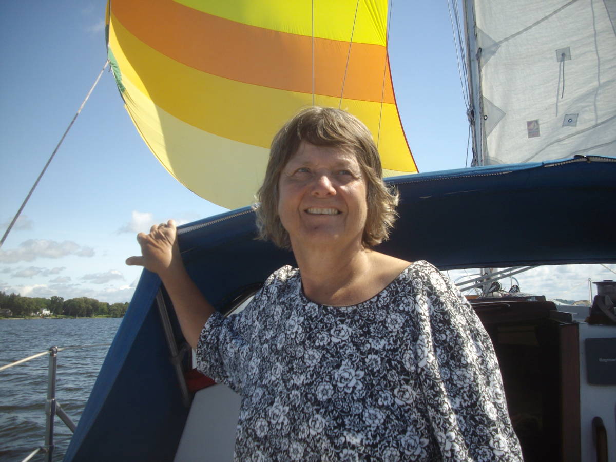 Picture showing a woman on a boat, smiling